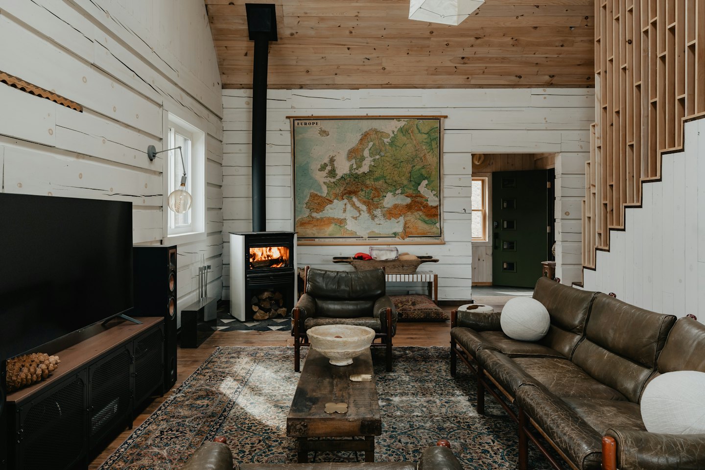 Gemütliches Wohnzimmer mit Kamin und Ledermöbeln.